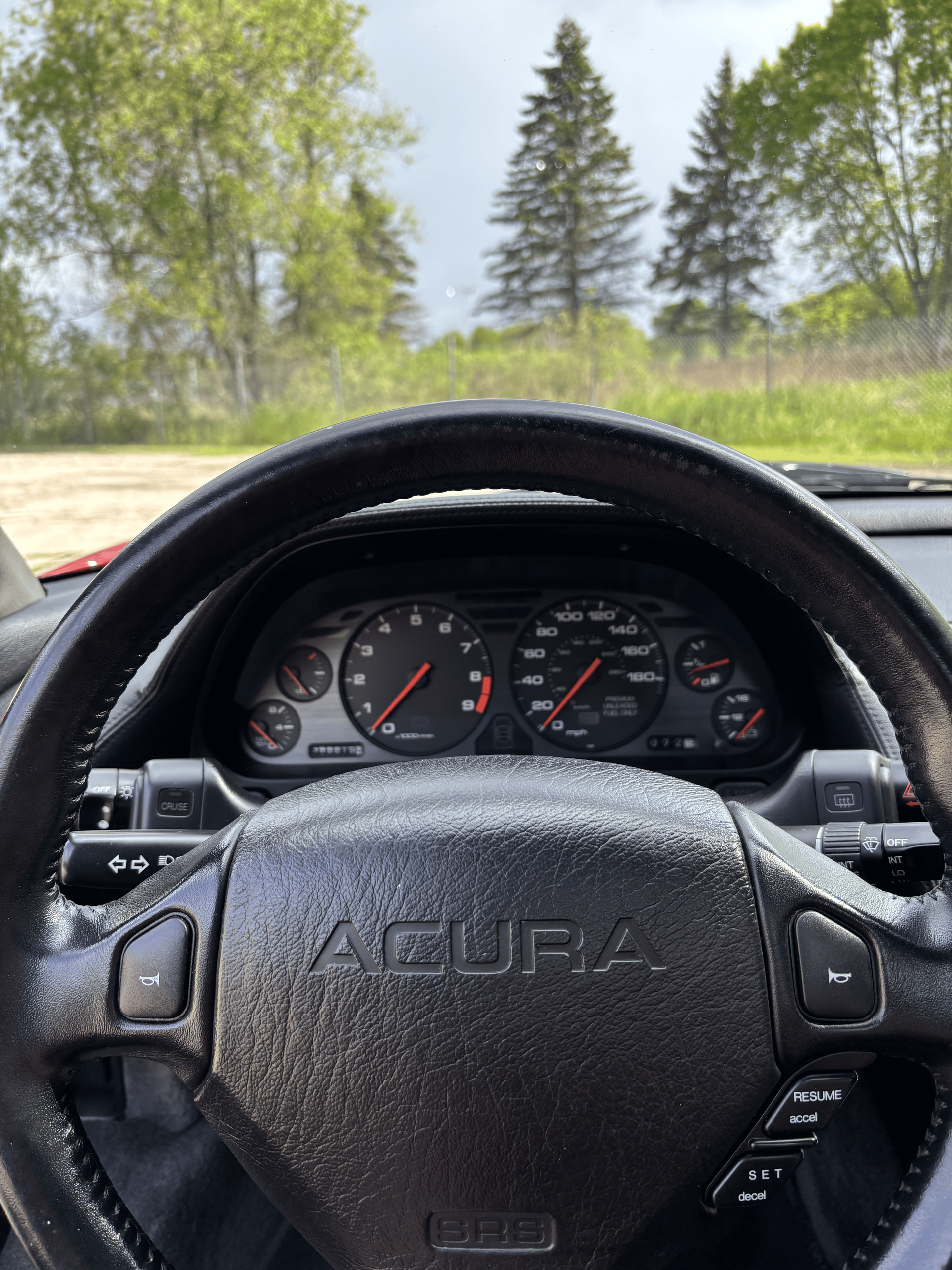 A close up of the steering wheel of an acura car