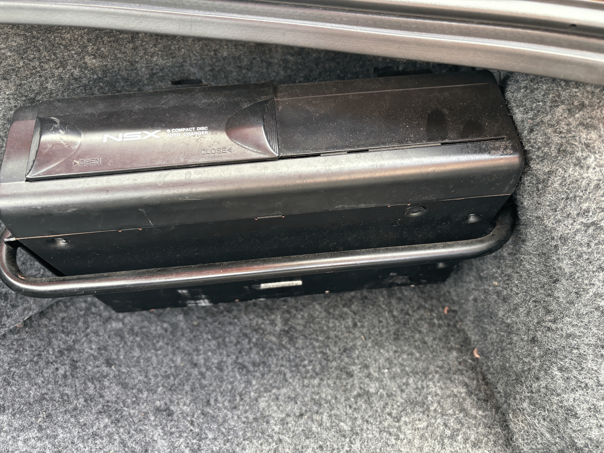 A black box is sitting in the trunk of a car.