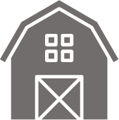 An icon of a barn with square windows and a door.