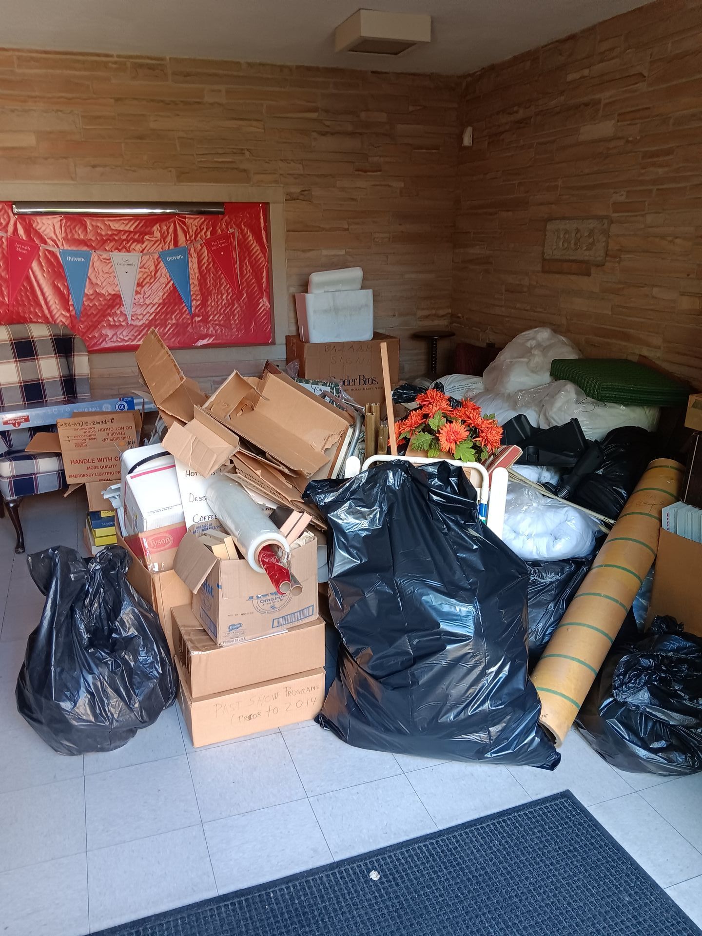 A room filled with boxes , bags , and flowers.