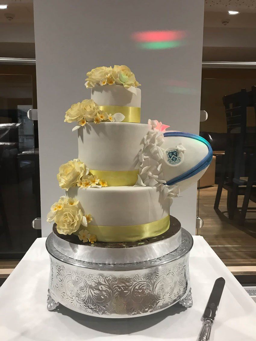 Three tier cream and yellow wedding cake