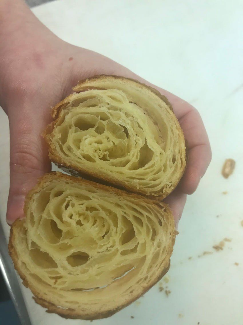 Two pastries being held up to the camera