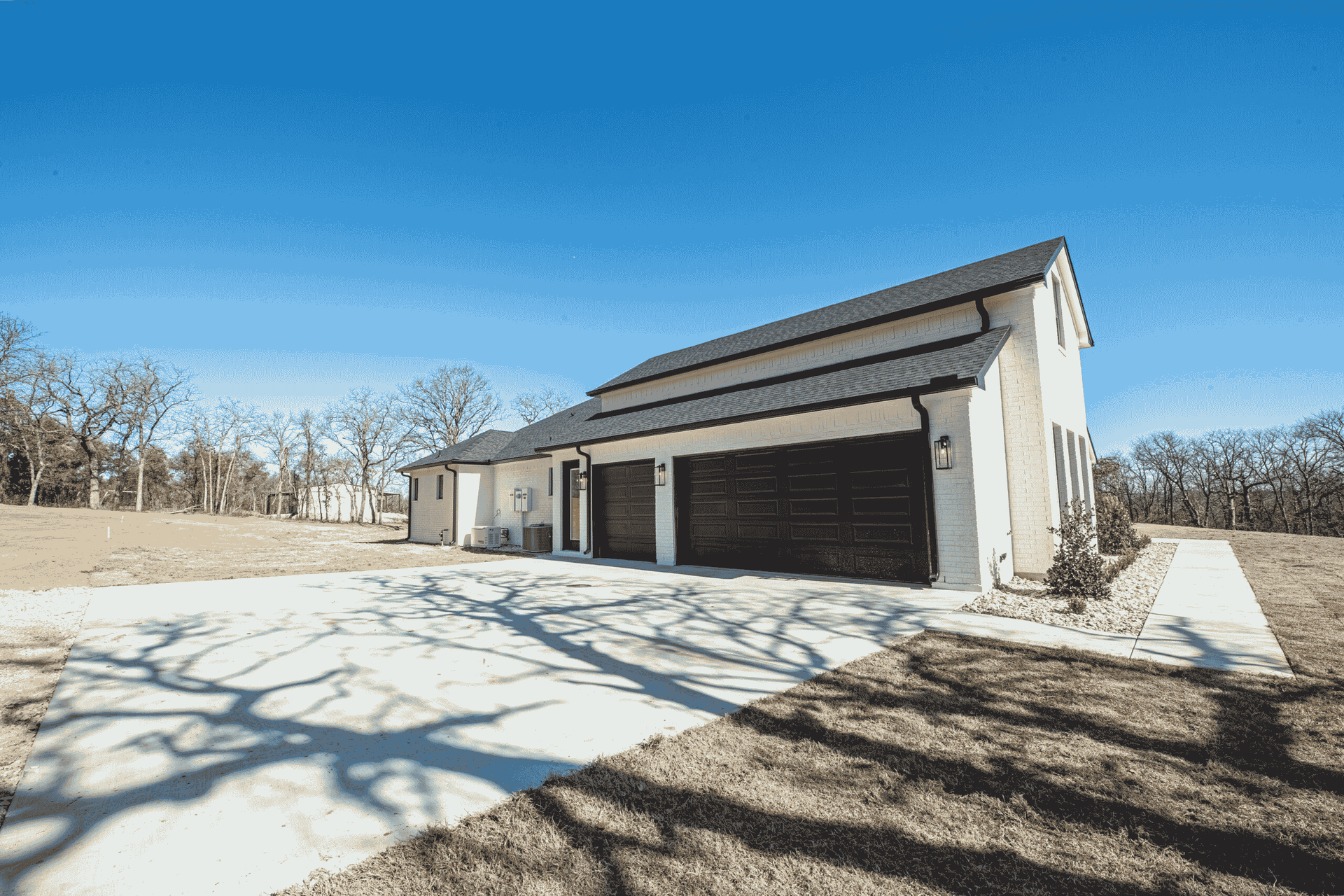 A large white house with a garage and a driveway.