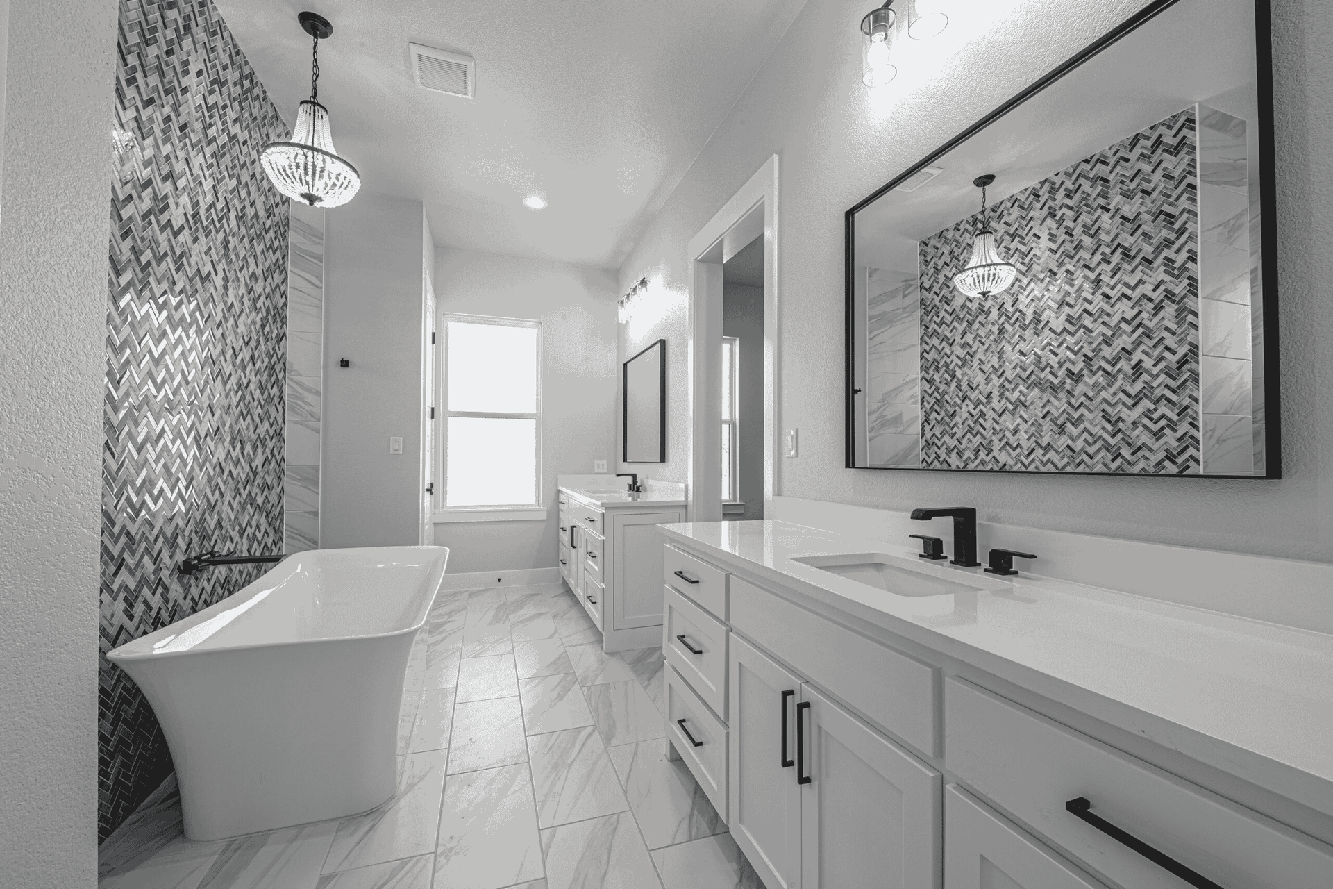 A black and white photo of a bathroom with two sinks and a bathtub.