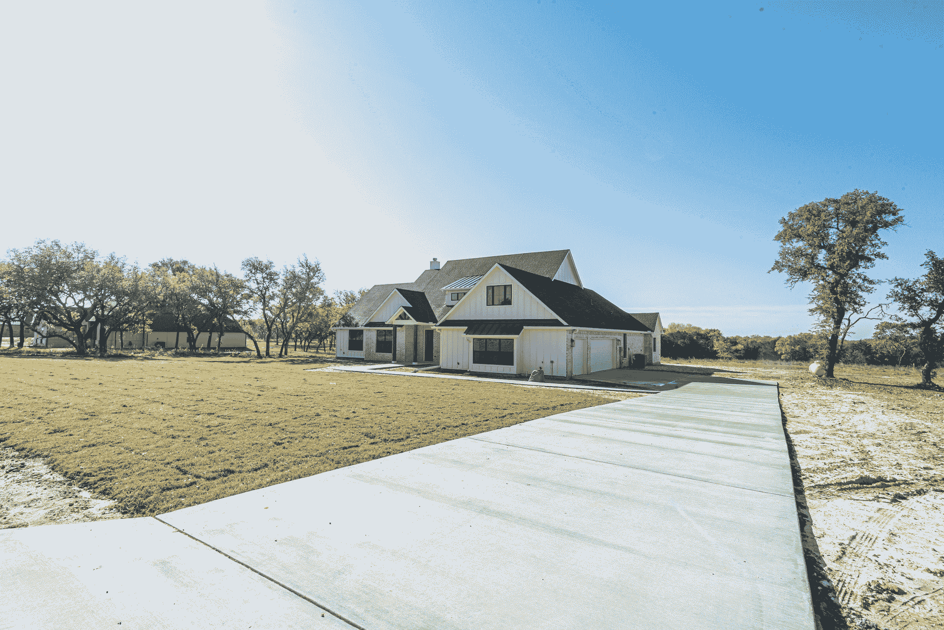 A house with a concrete driveway leading to it