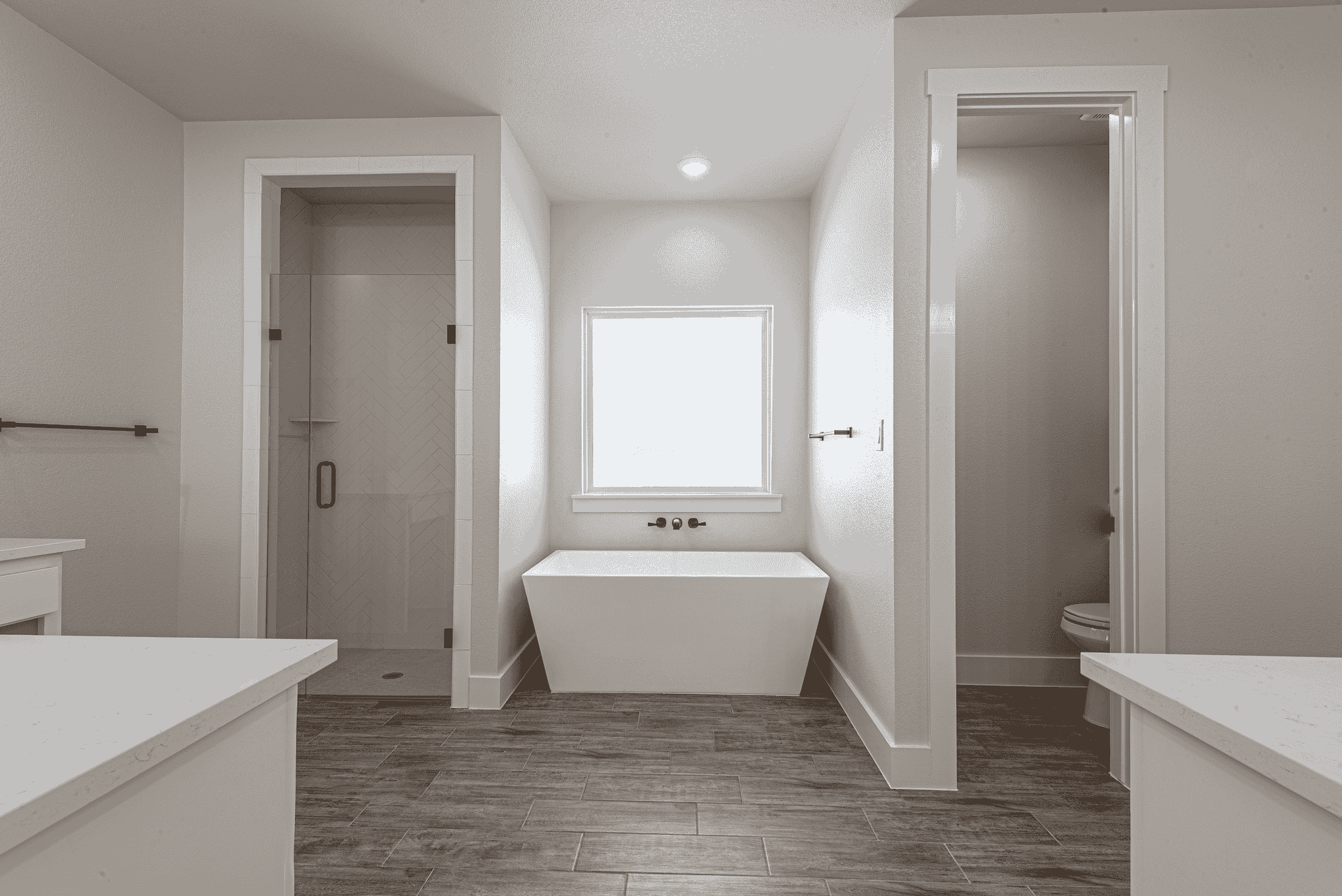 A bathroom with two tubs , a toilet , and a shower.