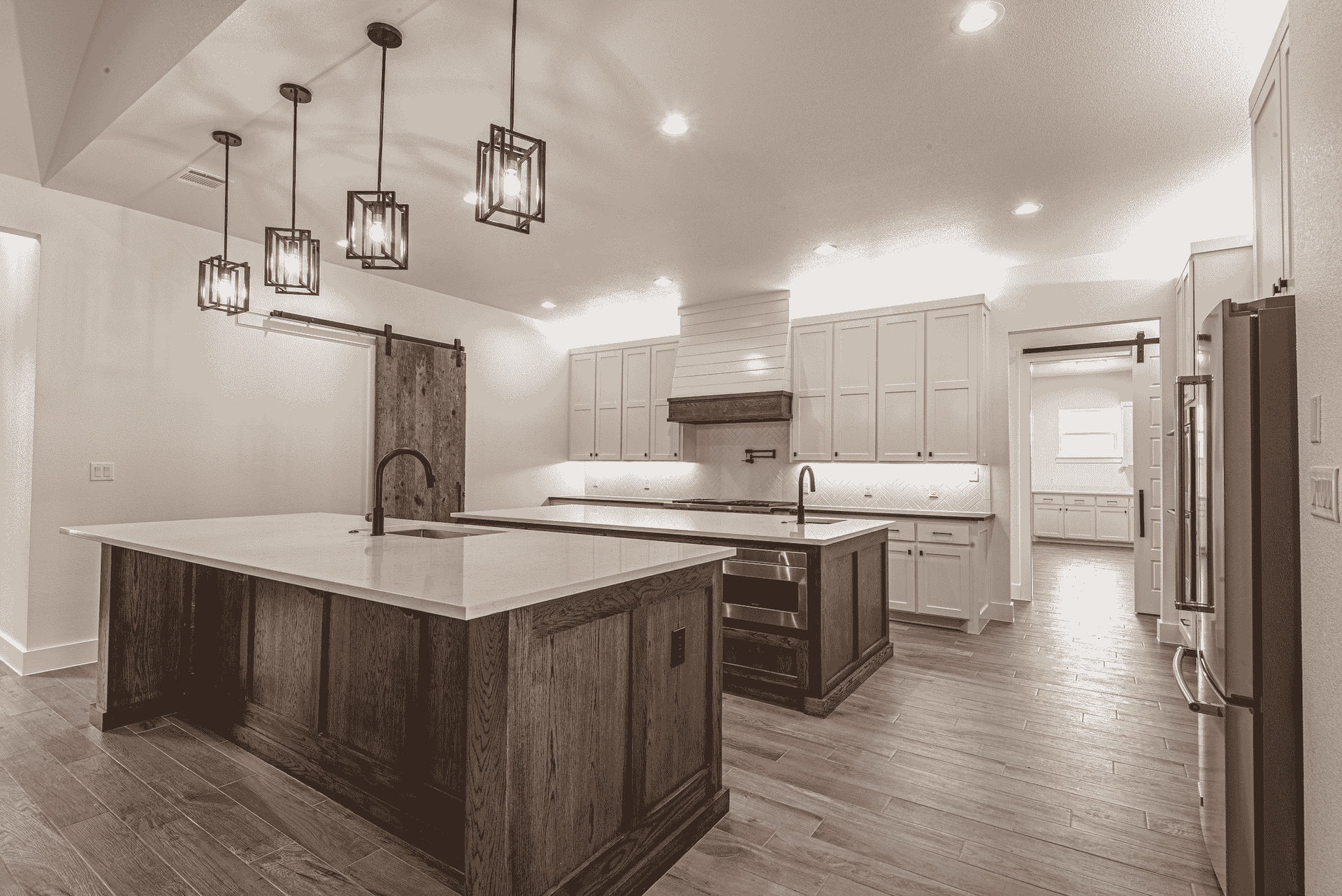 A black and white photo of a kitchen with a large island.