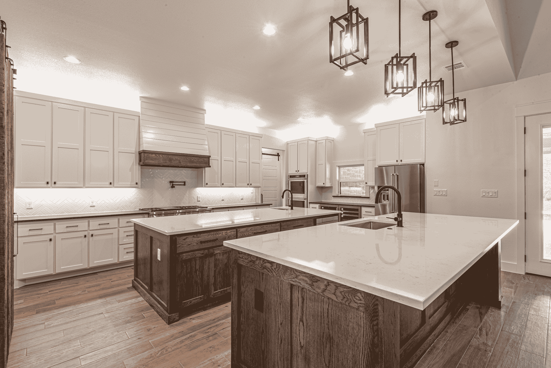 A kitchen with white cabinets and a large island in the middle.