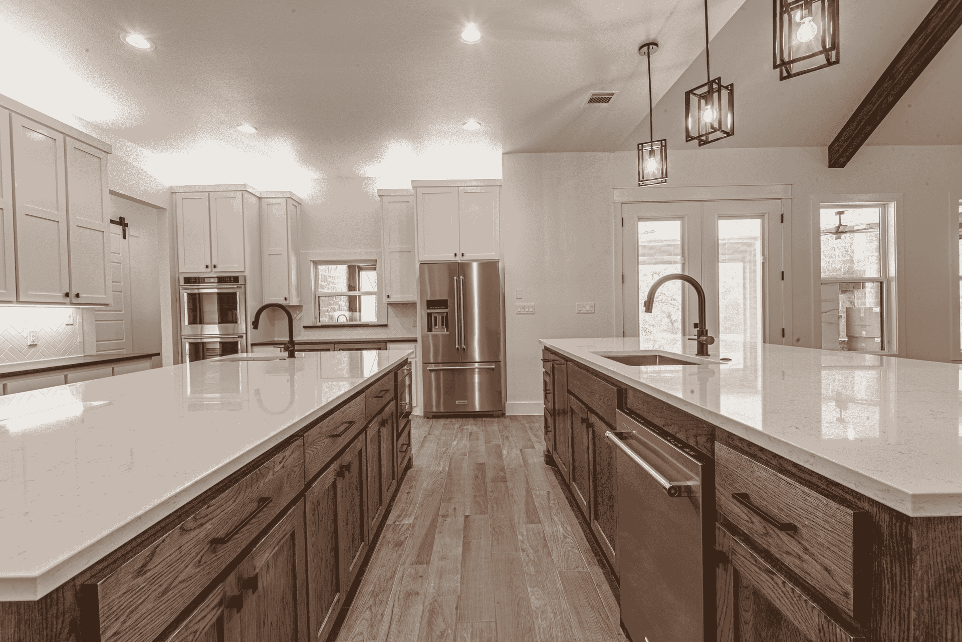 A black and white photo of a kitchen with stainless steel appliances and wooden cabinets.