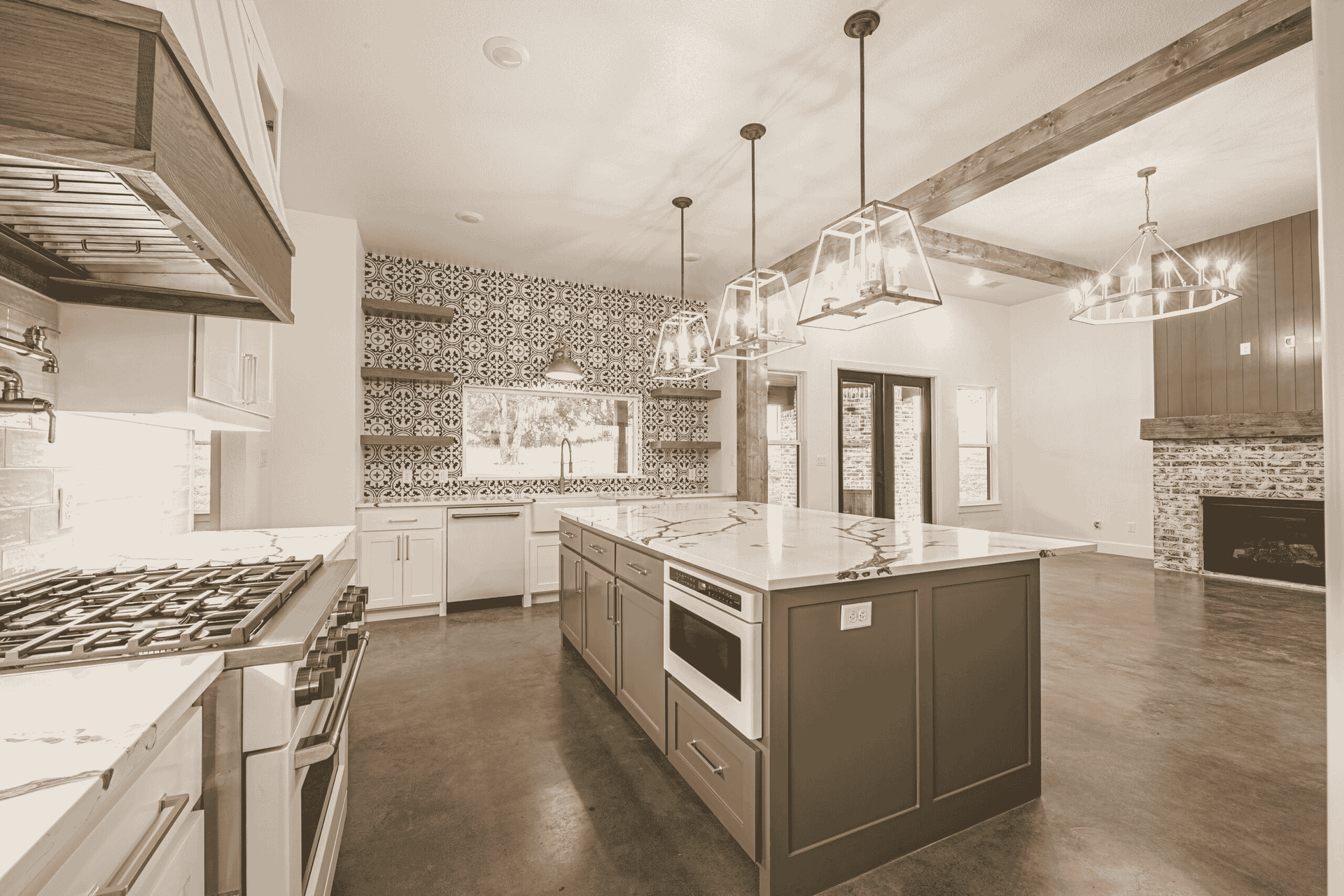 A black and white photo of a kitchen with a large island in the middle.
