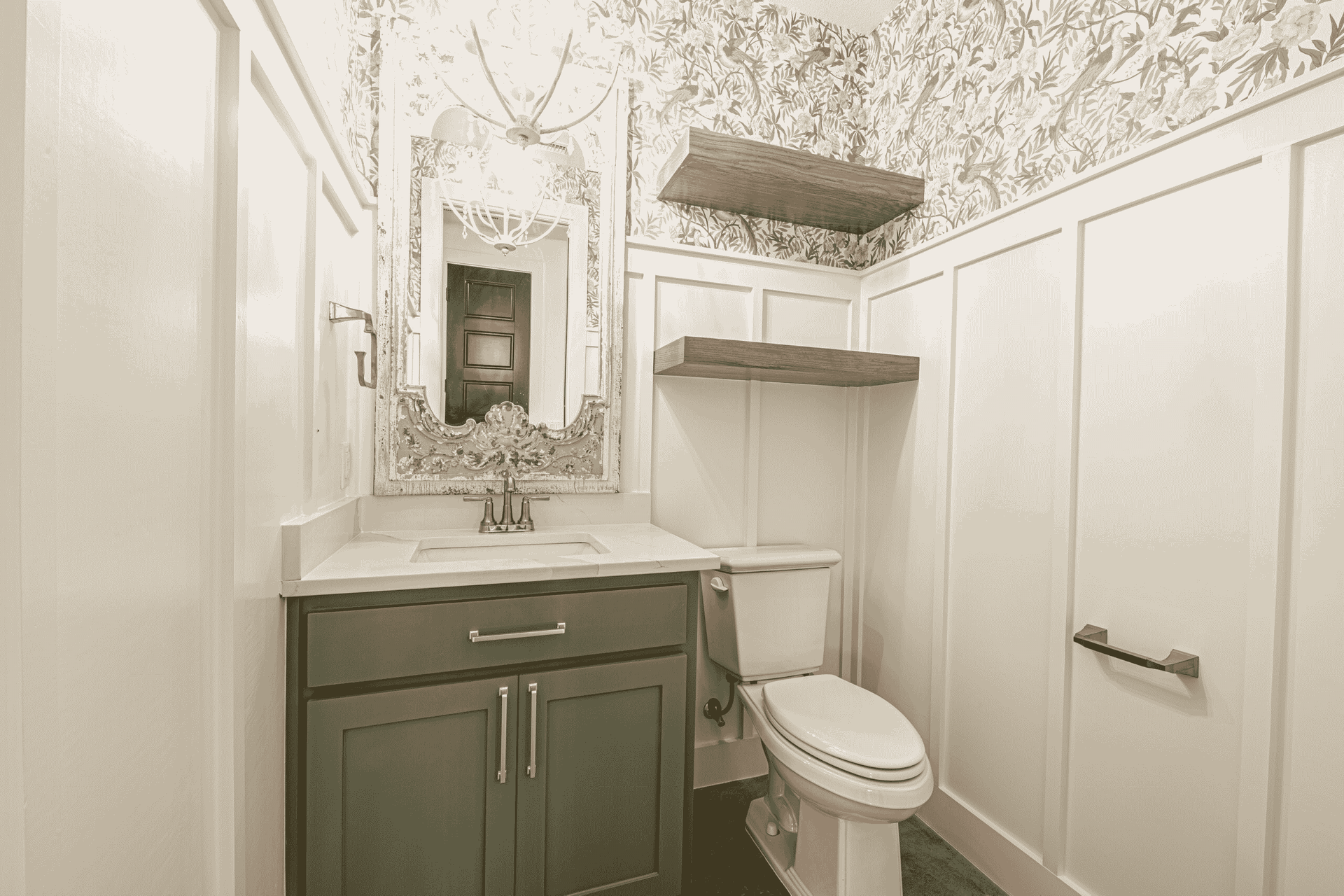 A bathroom with a toilet , sink and mirror.