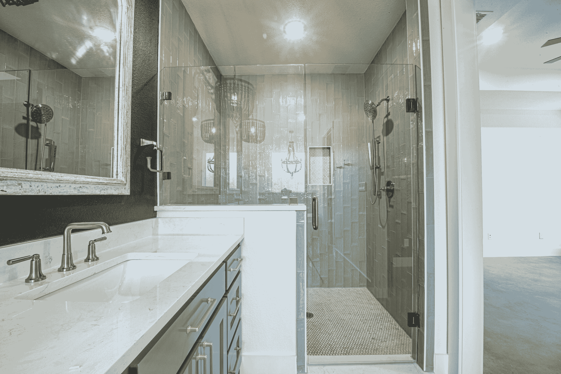 A bathroom with a walk in shower , sink and mirror.