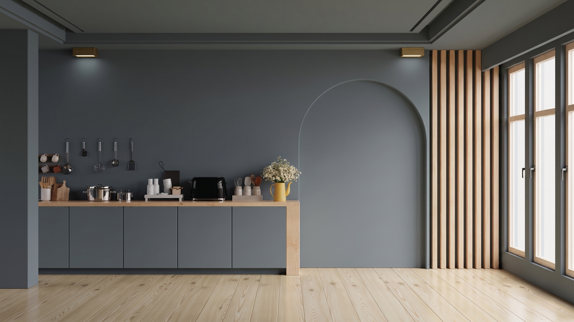 Cuisine moderne et minimaliste avec des armoires grises, des touches de bois et de grandes fenêtres.