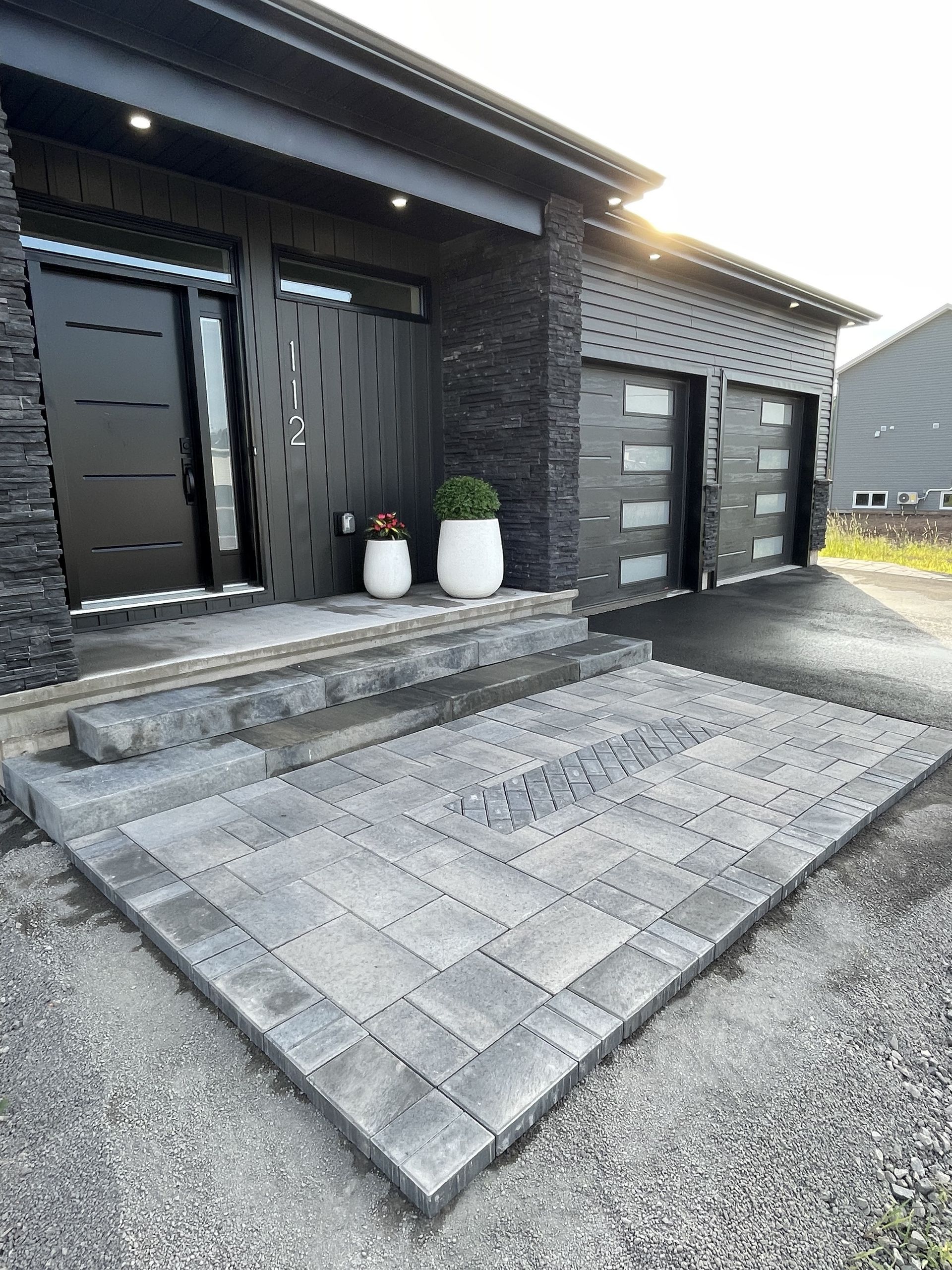 The front of a house with a patio in front of it.
