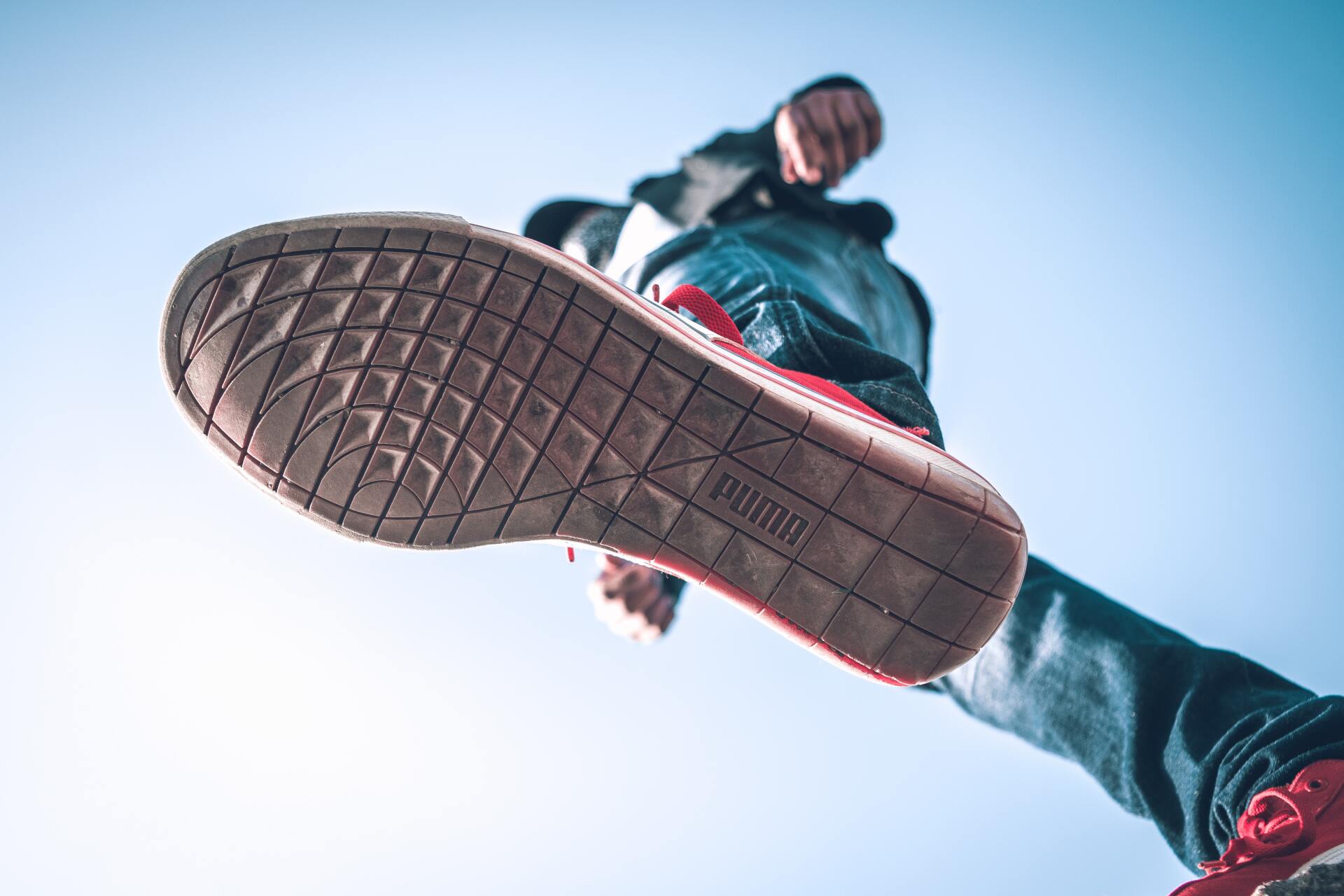 A person is jumping in the air with their foot in the air.