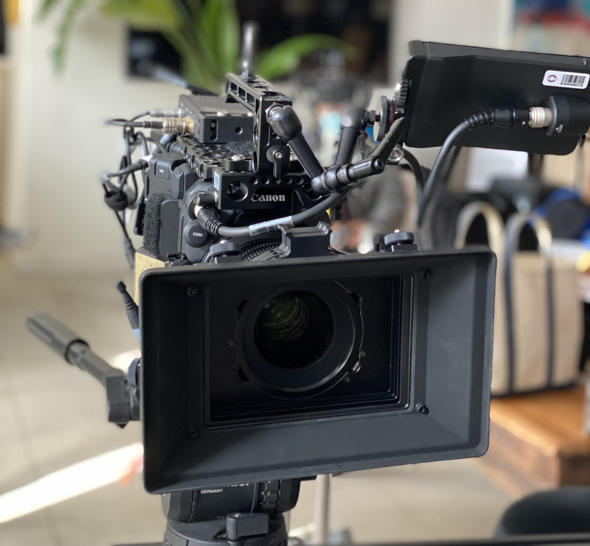 A camera is sitting on a tripod in a living room