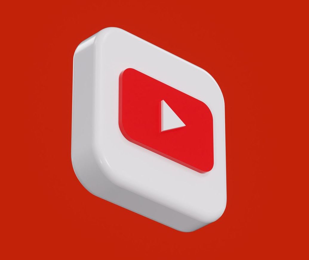 3D YouTube icon on a red background. White square with a red play button.