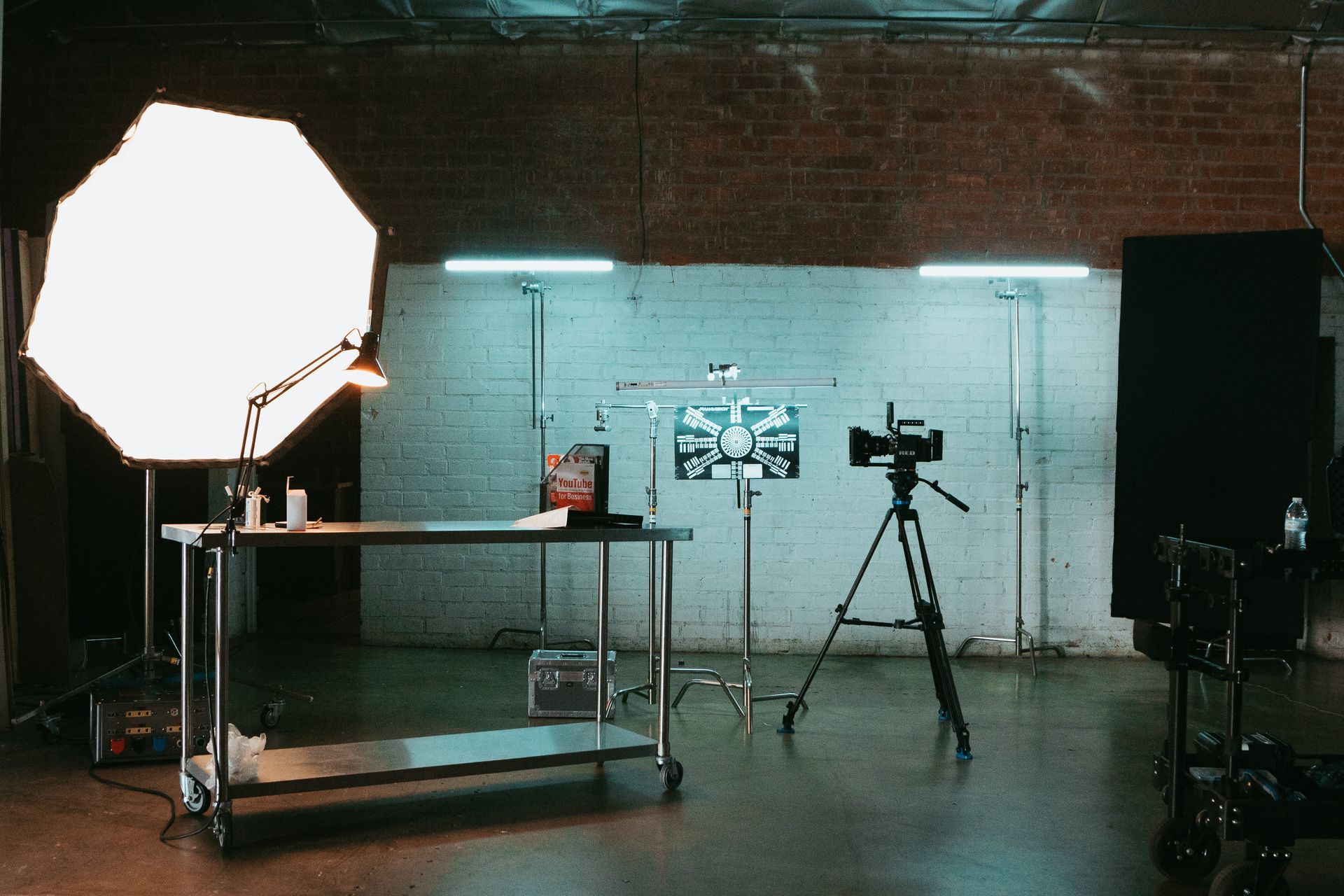 A camera is sitting on a tripod in a photo studio