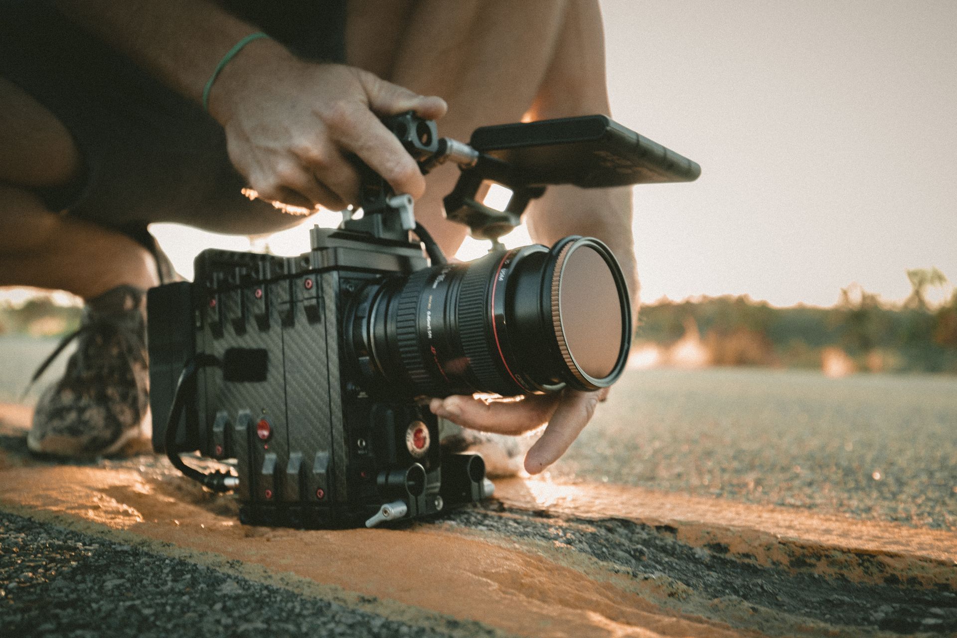 Handheld low angle of a camera operator holding a RED cinema camera Handheld low angle of a camera operator holding a RED cinema camera