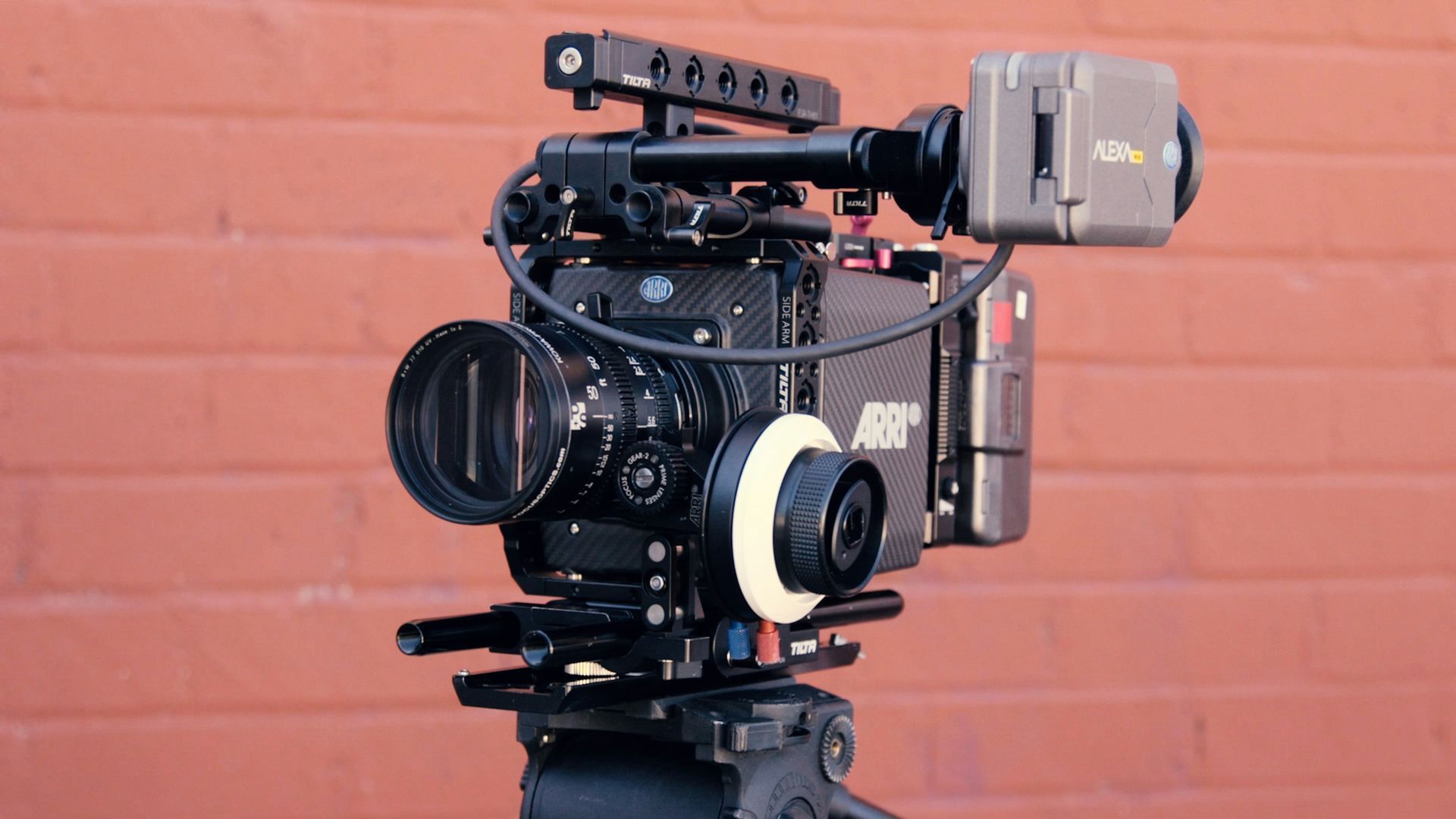 Close up Arri Alexa in front of a brick wall A camera is sitting on top of a tripod in front of a brick wall.