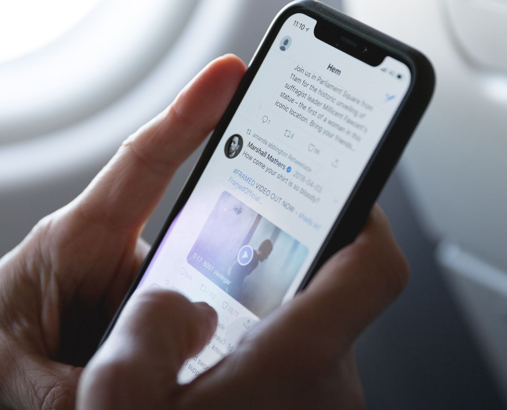 A person is holding a cell phone in their hand.