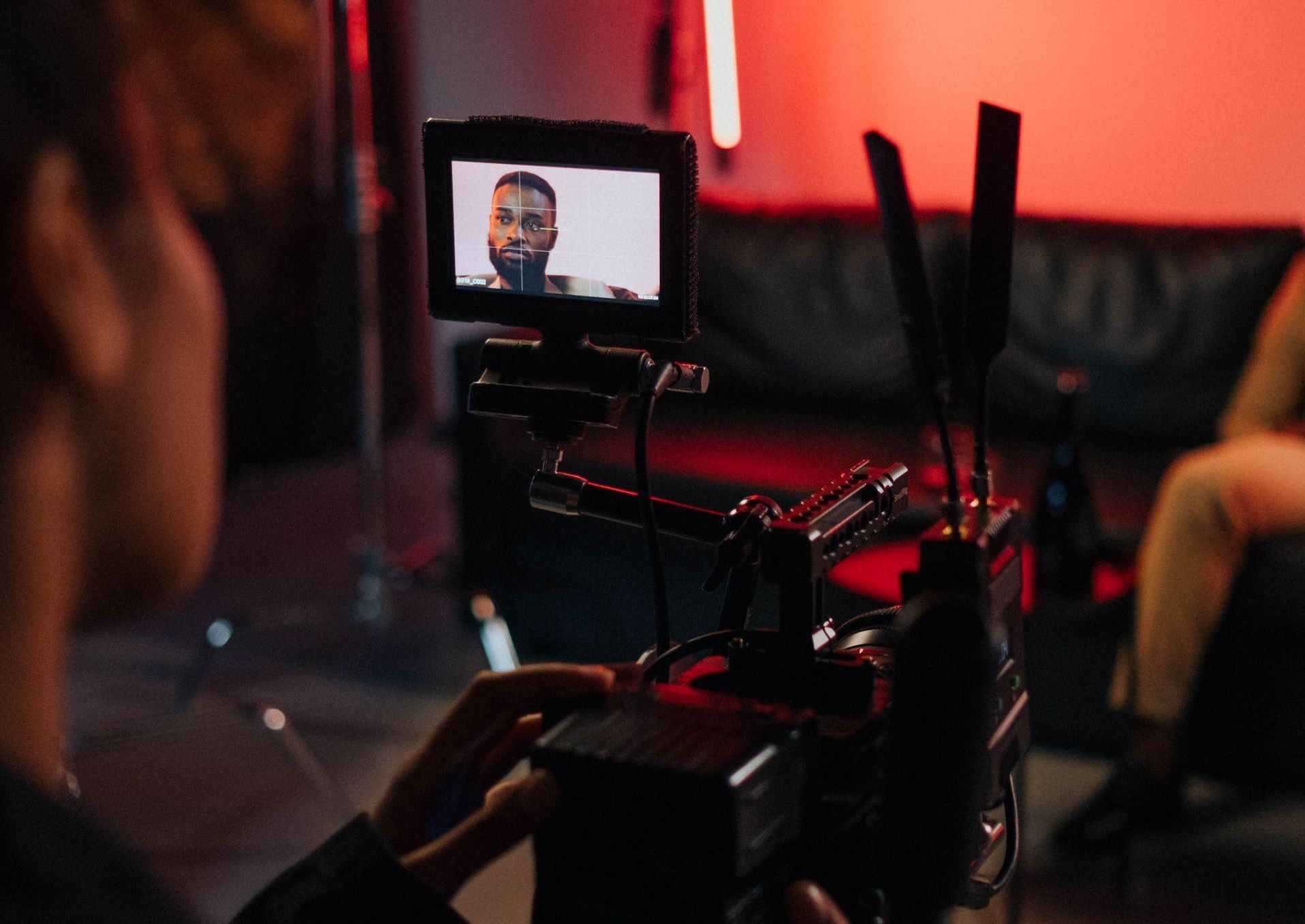 A man is recording a video with a camera.
