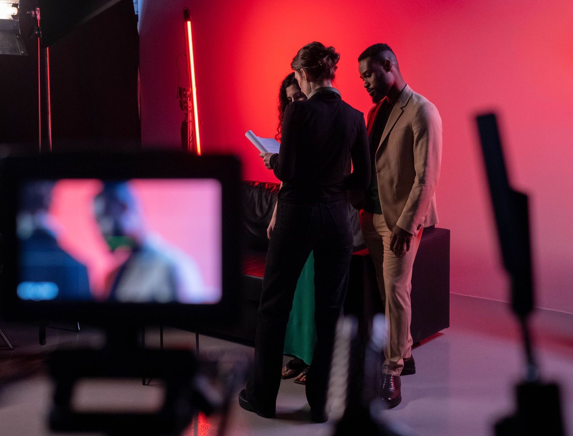 A group of people are standing in front of a camera.