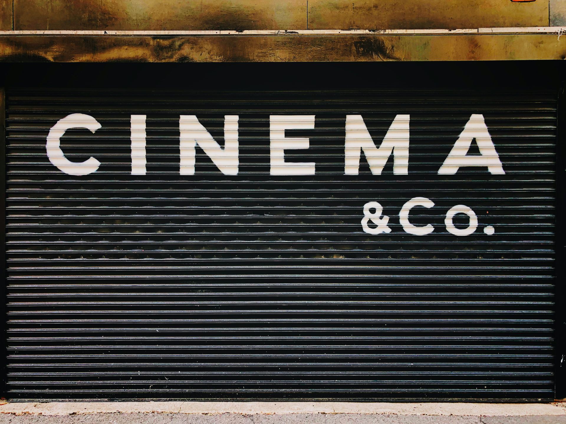 Cinema and co garage door A sign on a garage door that says cinema & co.