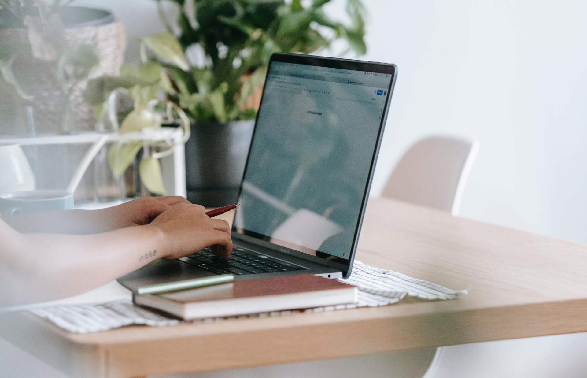 Close up laptop on desk with person working