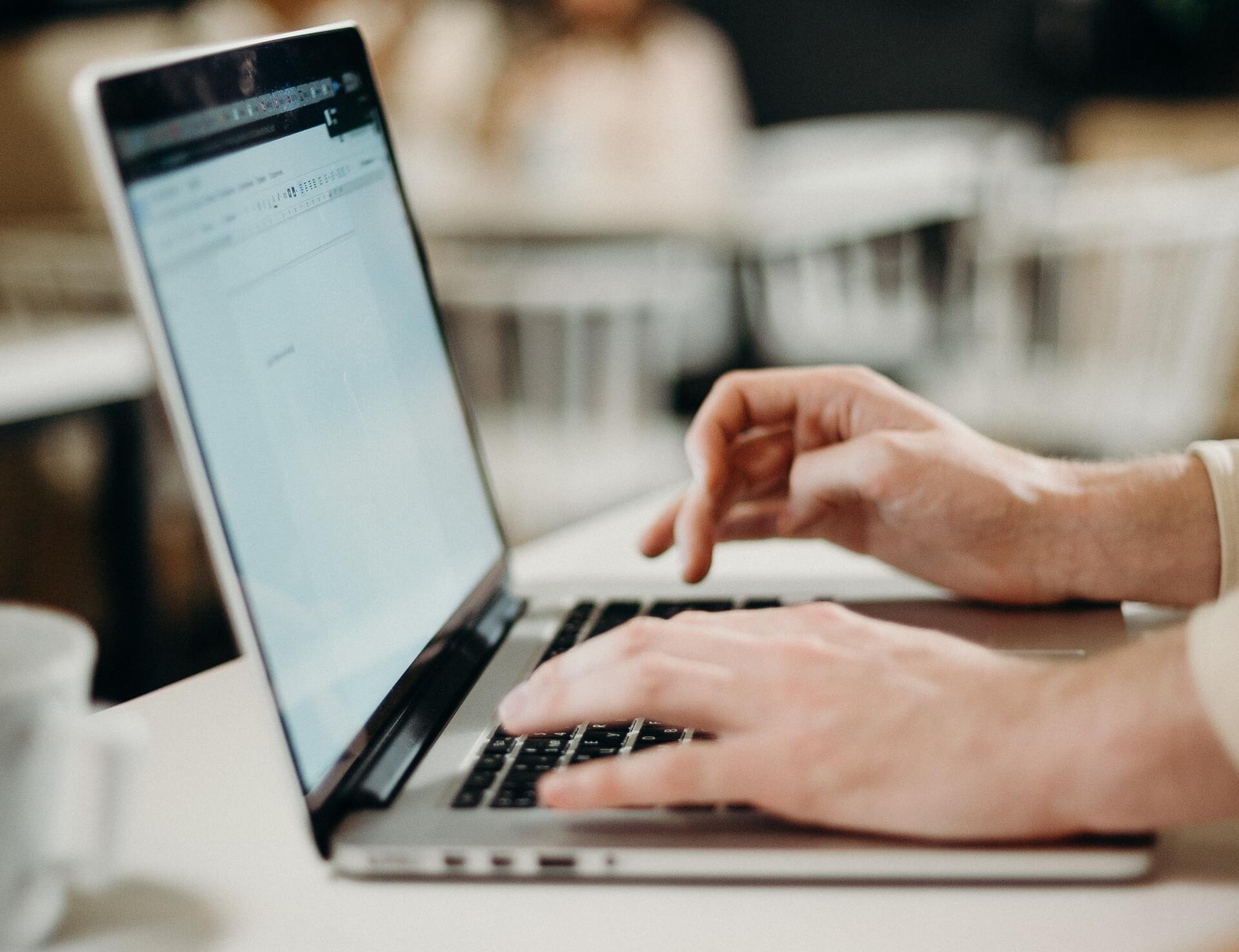 A person is typing on a laptop computer.