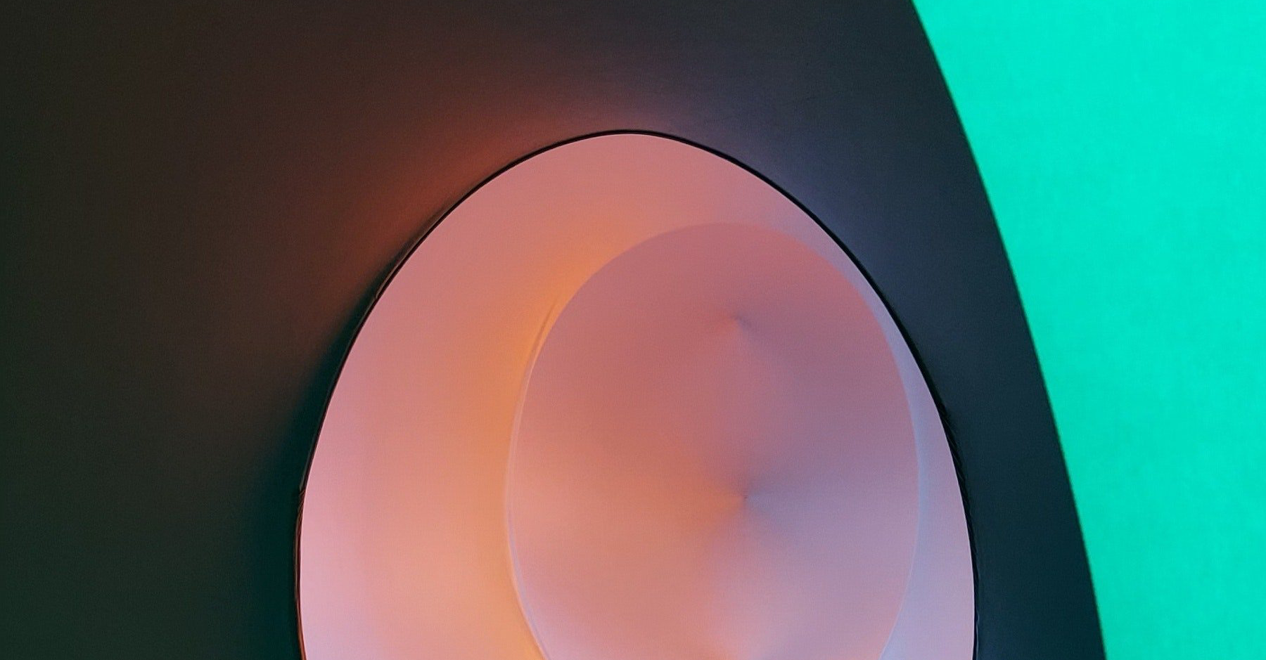 Abstract image of curvy colored walls A close up of a pink circle on a green background.