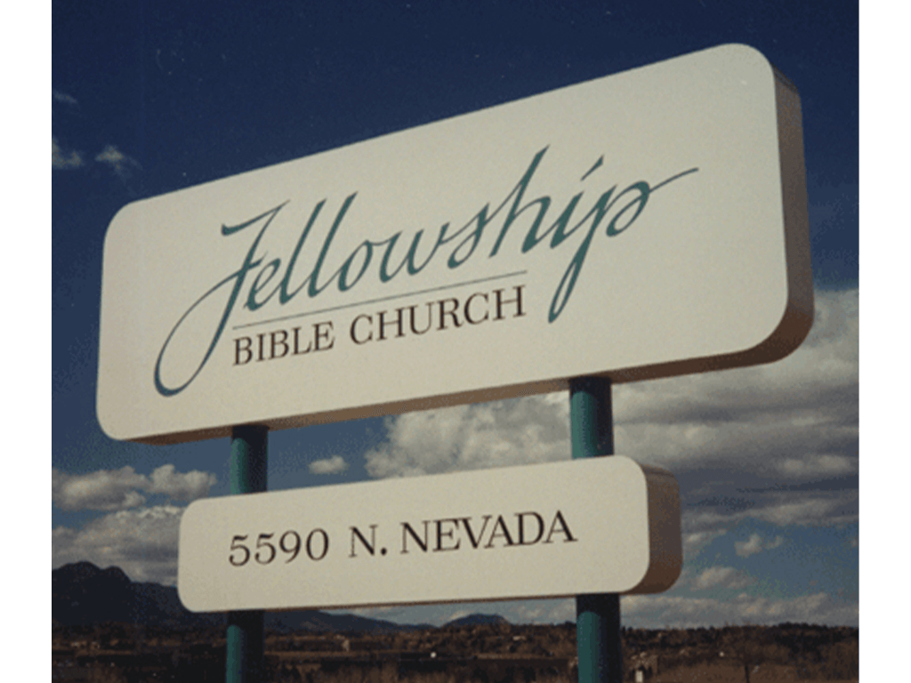 Tall, lighted, metal pole sign