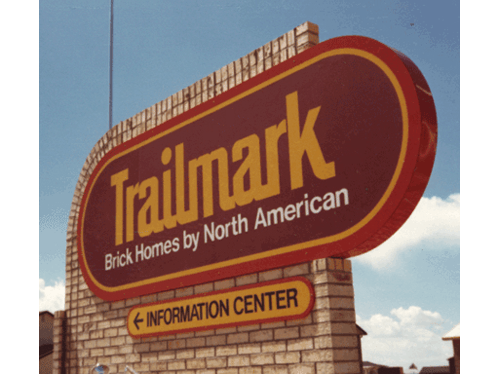 Metal sign incorporated into custom brick wall