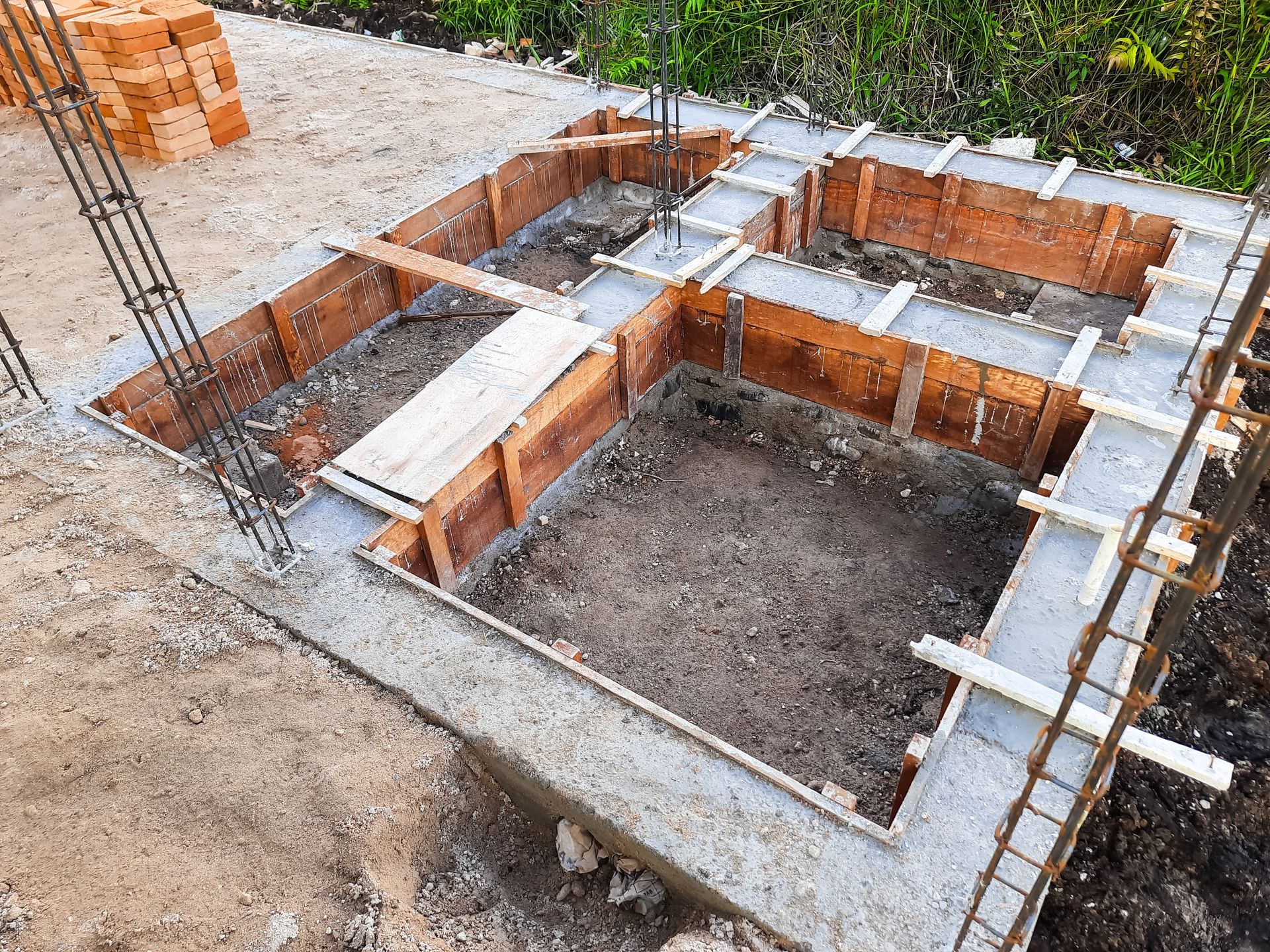 A concrete foundation for a house is being built.