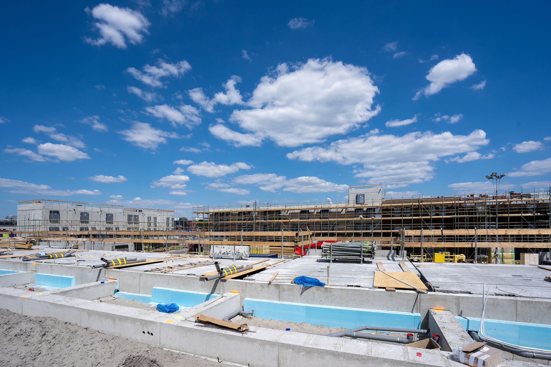 A construction site with a blue sky and clouds in the background.