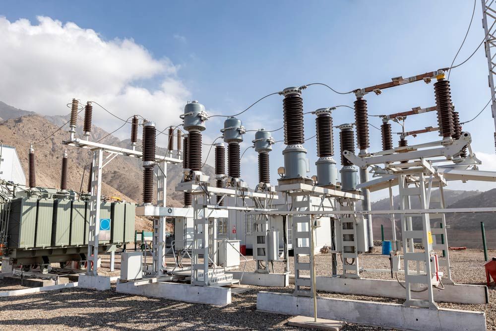 A Row of Electrical Equipment in a Field With Mountains in the Background — Country Powerline Constructions in Dubbo, NSW