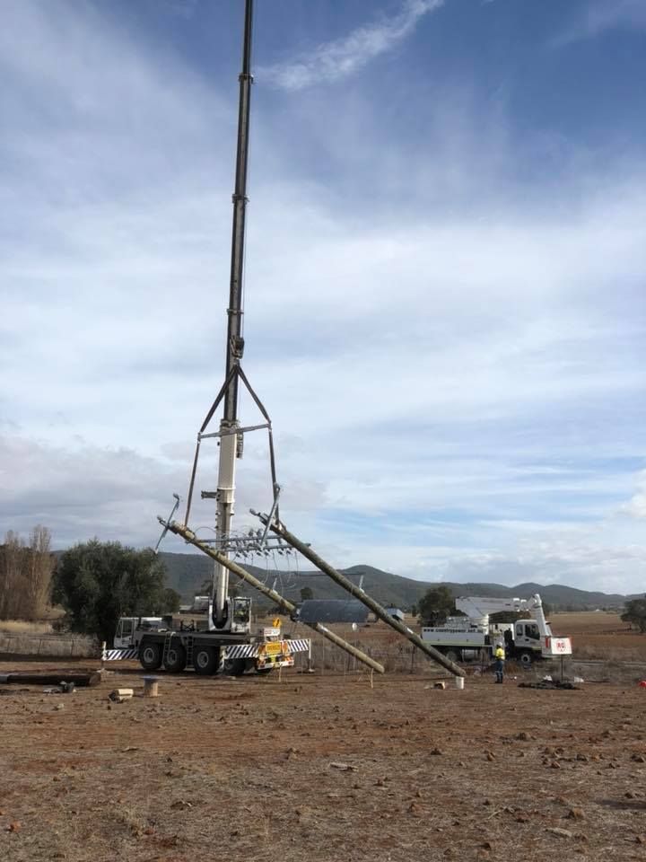 A Large Crane is Sitting in the Middle of a Dirt Field — Country Powerline Constructions in Hunter Valley, NSW
