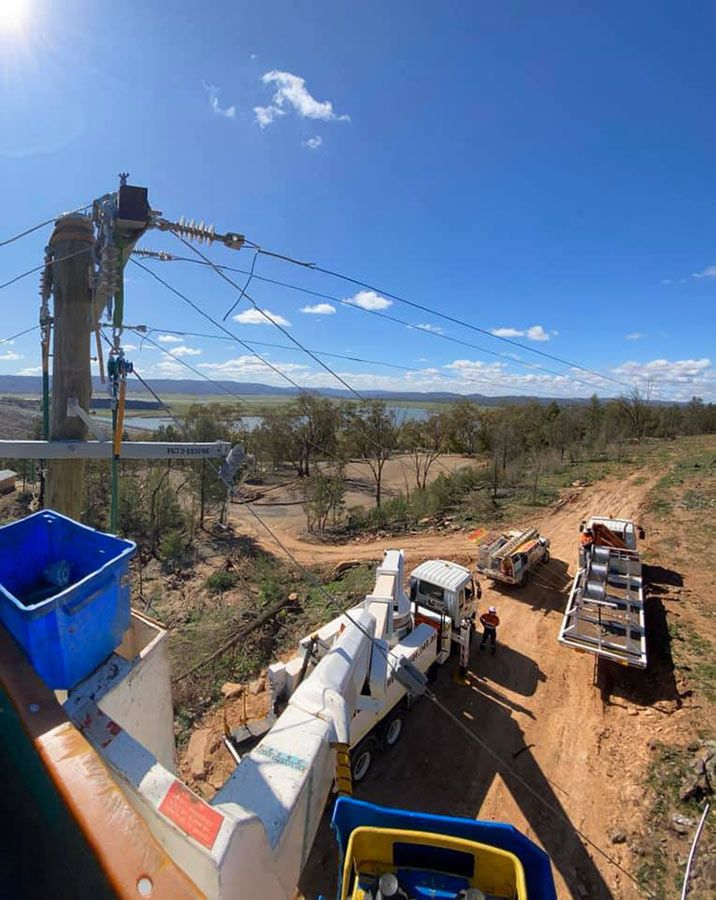 A Group of Trucks Are Parked on the Side of a Dirt Road — Country Powerline Constructions in Warren, NSW