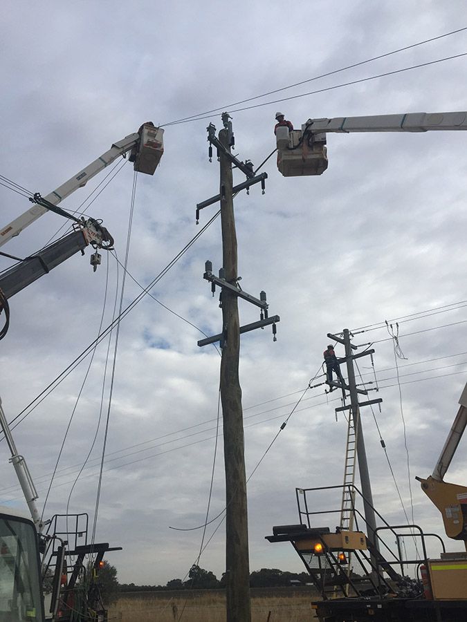 A Group of Construction Workers Are Working on a Power Line — Country Powerline Constructions in Bathurst, NSW