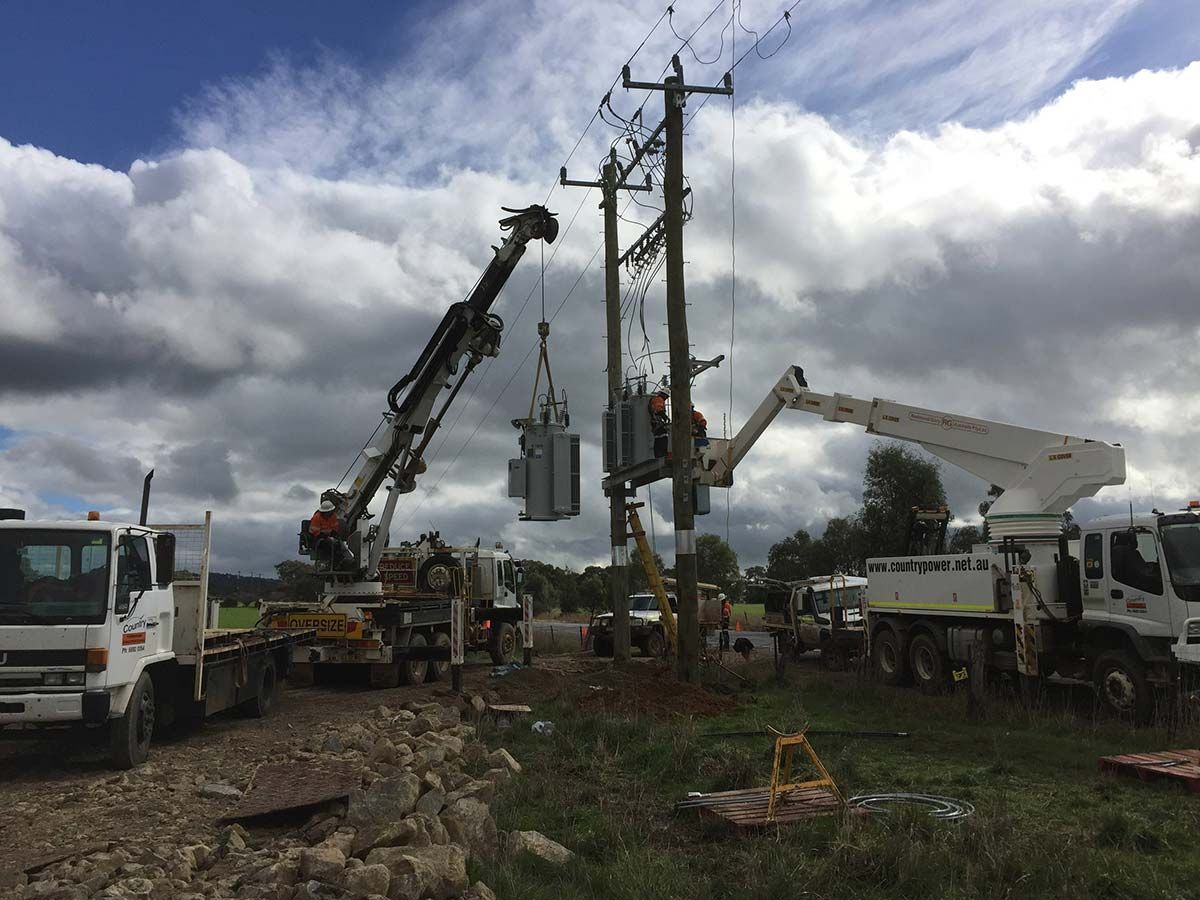 A Crane is Lifting a Transformer on Top of a Power Pole — Country Powerline Constructions in Walget, NSW
