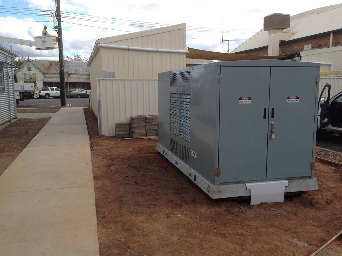 A Large Gray Box is Sitting in the Dirt Next to a Sidewalk — Country Powerline Constructions in Dubbo, NSW