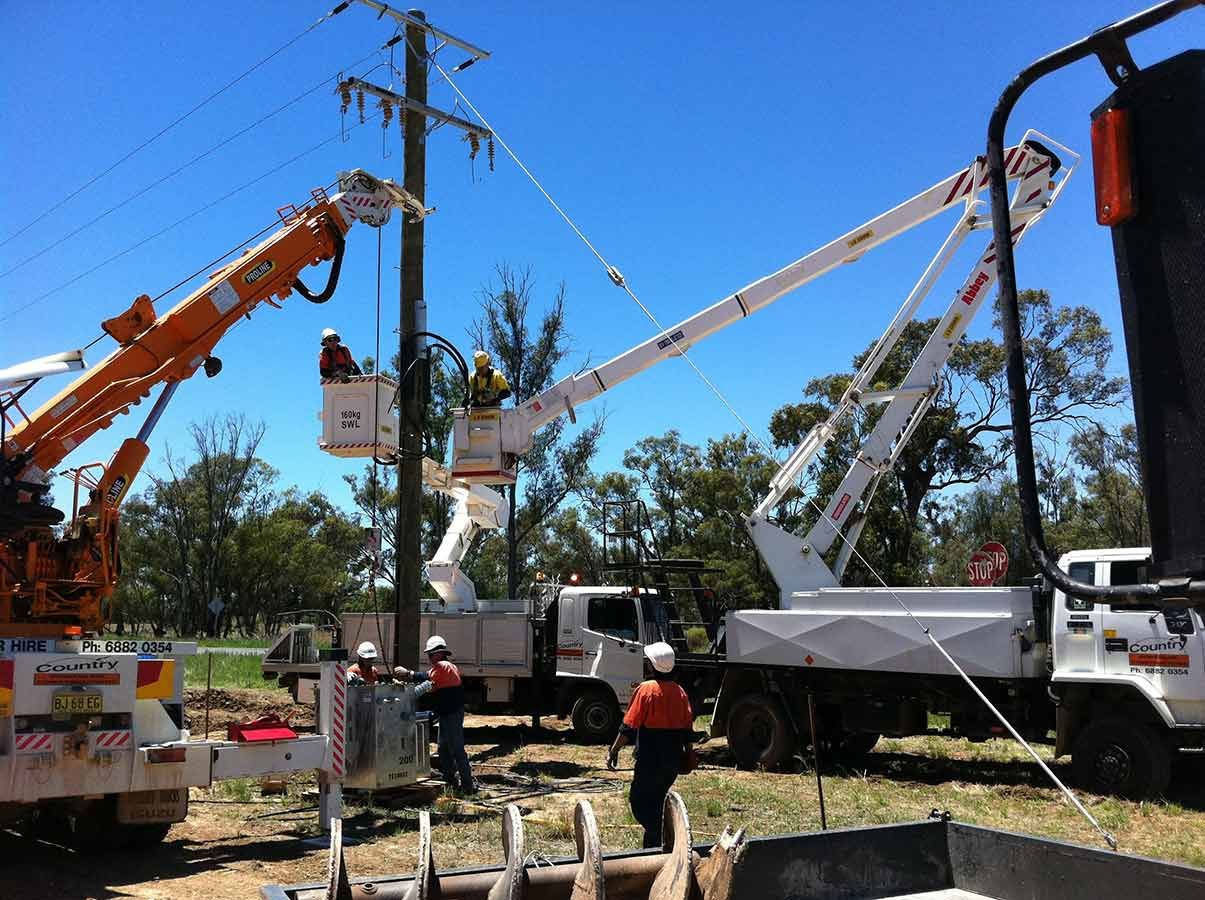 A Man in a Bucket is Working on a Power Line — Country Powerline Constructions in Dubbo, NSW