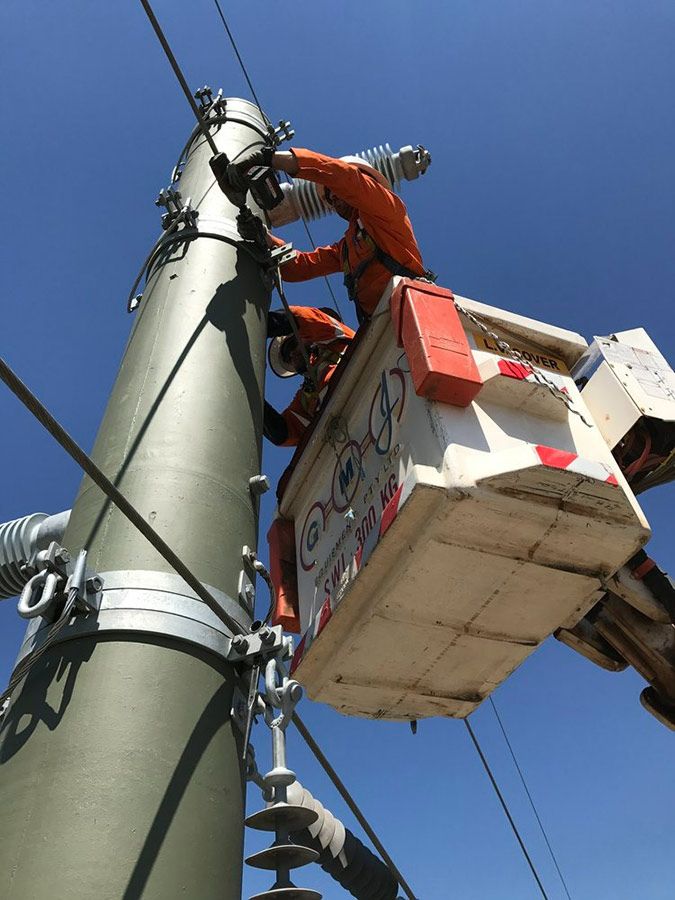A Man in a Bucket is Working on a Power Pole — Country Powerline Constructions in Dubbo, NSW