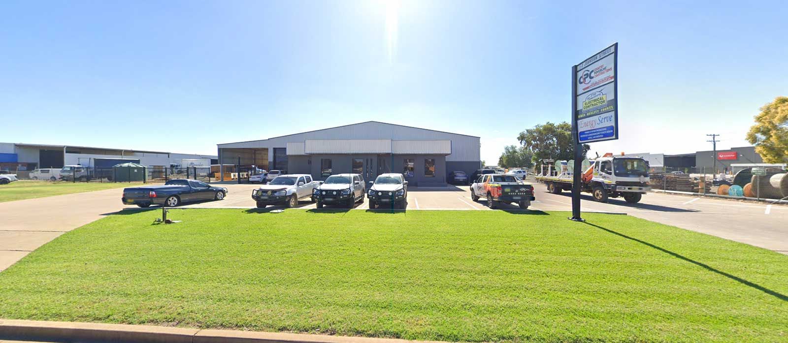 A Row of Cars Are Parked in Front of a Building — Country Powerline Constructions in Dubbo, NSW