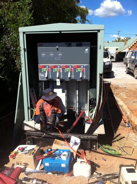 A Man is Working on an Electrical Box in a Trailer — Country Powerline Constructions in West Wylong, NSW