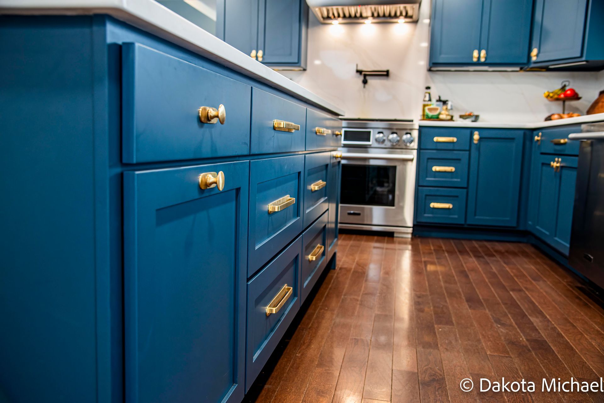 Modern kitchen with wood cabinets, white tile backsplash, stainless appliances, and concrete floor