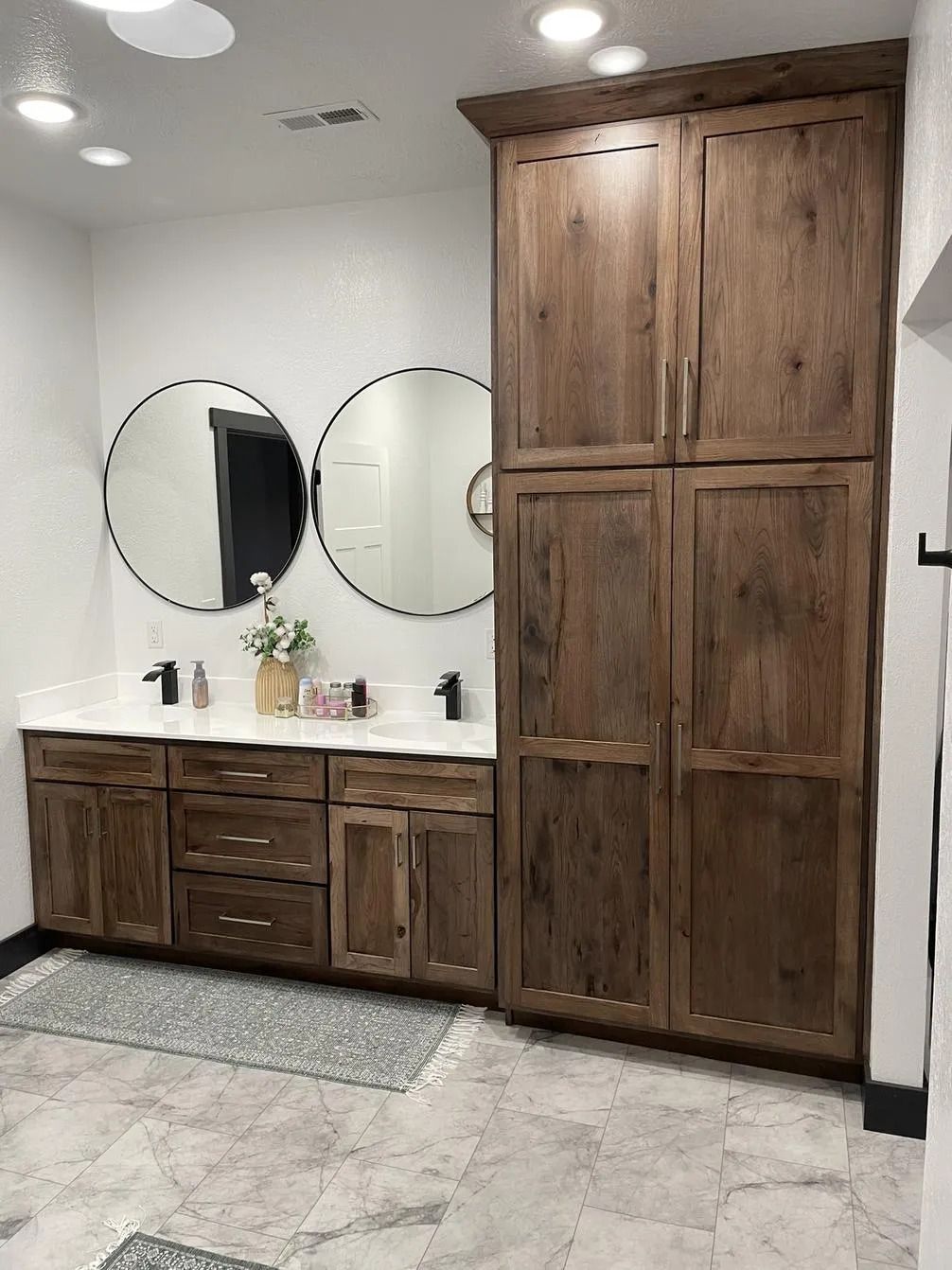 Modern bathroom vanity with white countertop, sink, and wood slat cabinet Modern bathroom vanity with white countertop, sink, and wood slat cabinet