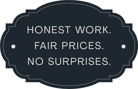Dark sign with white text: “HONEST WORK. FAIR PRICES. NO SURPRISES.” Dark sign with white text: “HONEST WORK. FAIR PRICES. NO SURPRISES.”