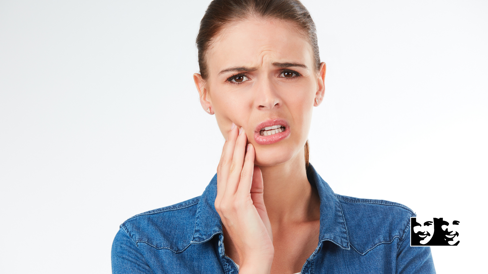 A woman is holding her mouth in pain because of a toothache.
