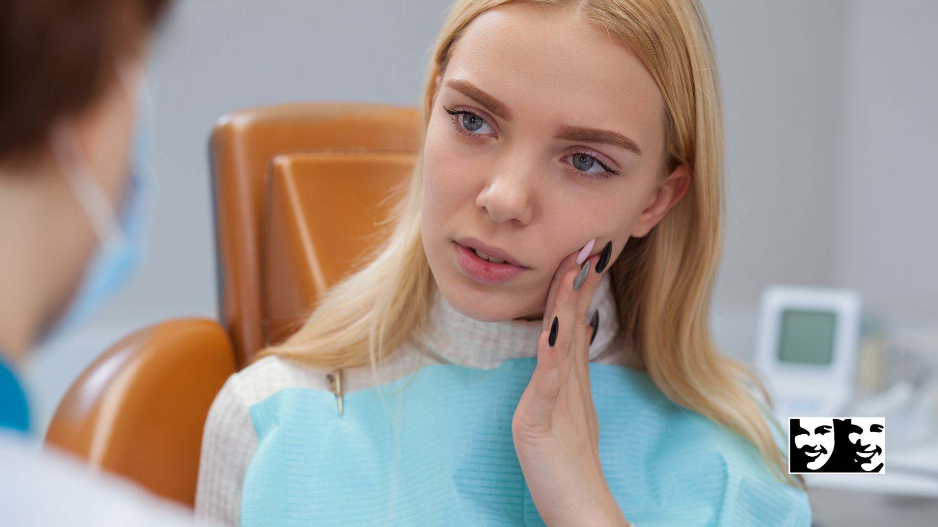A woman is sitting in a dental chair with a toothache.